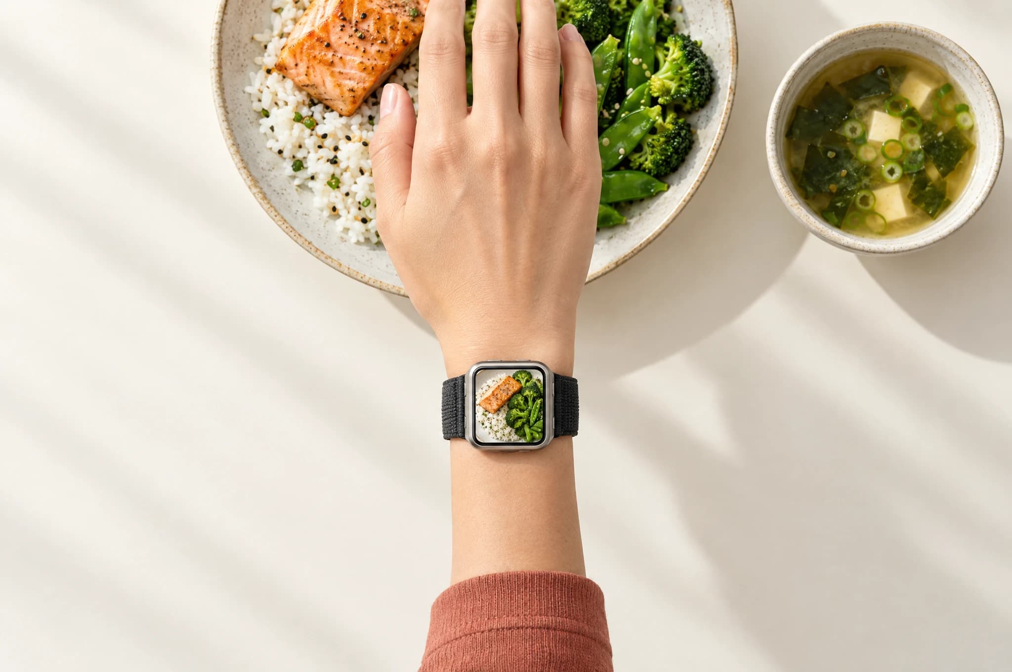 A right wrist seen from above, with food visible on the InHand Watch screen